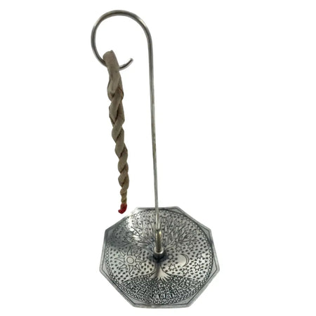 Silver-plated octagonal candle holder with engraved tree of life design and twisted rope hanging from curved metal hook