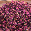 A pile of dried rose petals in deep magenta and faded yellow hues with crinkled edges weighing 0.5kg