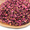 A pile of dried rose petals in deep magenta and burgundy with yellow edges weighing 0.5kg