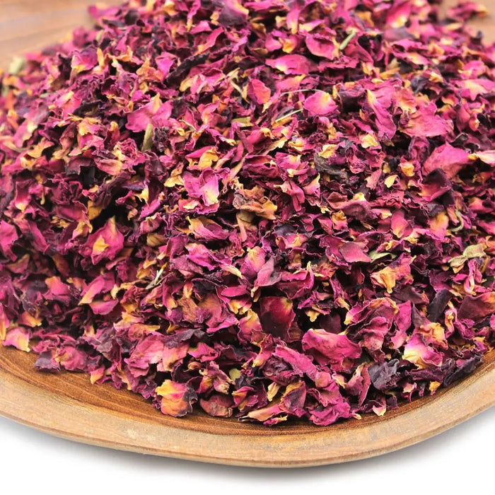 A pile of dried rose petals in deep magenta and burgundy with yellow edges weighing 0.5kg