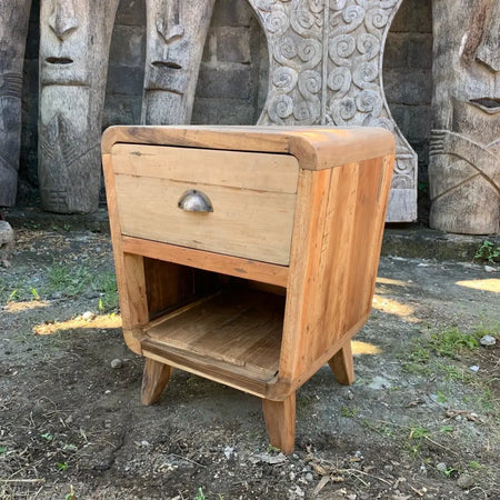 Round-edged bedside table with a drawer and shelf in light brown recycled wood for home decor and bedroom use