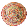 A round woven rug with concentric rings in red pink green blue and beige made of jute and recycled cotton fibers