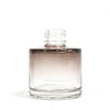 Clear glass round reed diffuser bottle with gradient brown liquid and screw cap for bamboo reed diffuser use