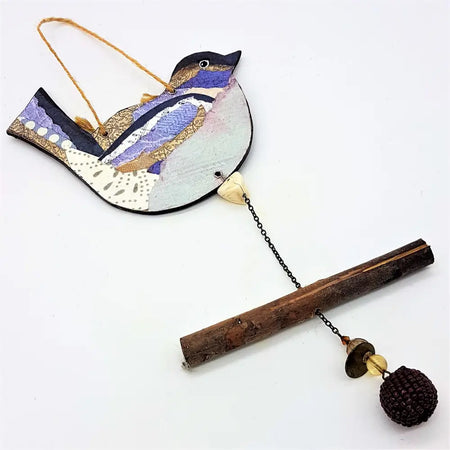 Rustic bird hanging decoration handcrafted with patchwork in purple blue and cream featuring intricate wing patterns
