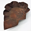 Rust-colored irregular ceramic bowl with textured surface and hammered iron leaf-like contours large dish