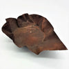 Rust-colored hammered iron leaf dish with a textured weathered surface large rustic hammered iron bowl