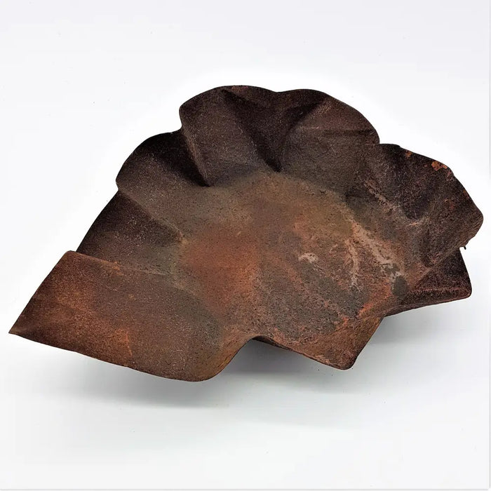 Rust-colored leaf-shaped rustic hammered iron dish with a textured weathered surface for decor or serving