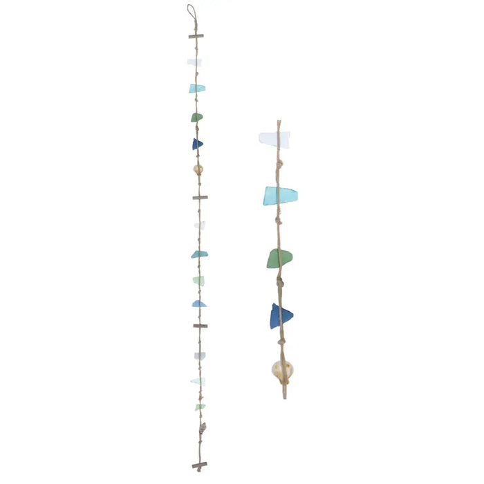 Two rustic sea glass hanging mobiles with blue and green sea glass, shells, and driftwood pieces on strings