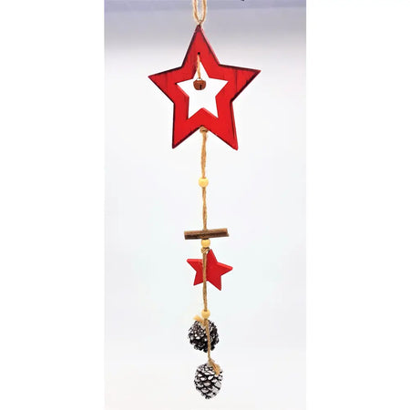Rustic red wooden star ornament with white center hanging from twine decorated with pine cones and small red stars