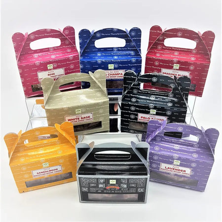 Colorful glossy cardboard boxes with handle tops and clear windows showing satya backflow dhoop incense cones