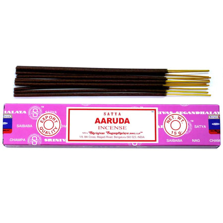 Pink rectangular box of satya incense sticks aaruda with white label red text and gold tipped dark brown sticks arranged above