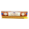 A box of satya incense sticks dark cinnamon with brown white label and gold tipped sticks arranged neatly in front