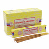 Yellow cardboard box of satya incense sticks labeled divine blessing for aromatic use and meditation
