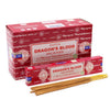 Red cardboard box of satya incense sticks dragon blood with gold wooden sticks arranged beside it
