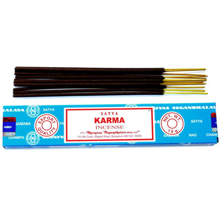 A pack of satya incense sticks karma with dark brown sticks and golden tips in a blue box with red and white branding