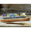 A wooden satya incense sticks holder with smooth polished surface and natural wood grain for money incense use