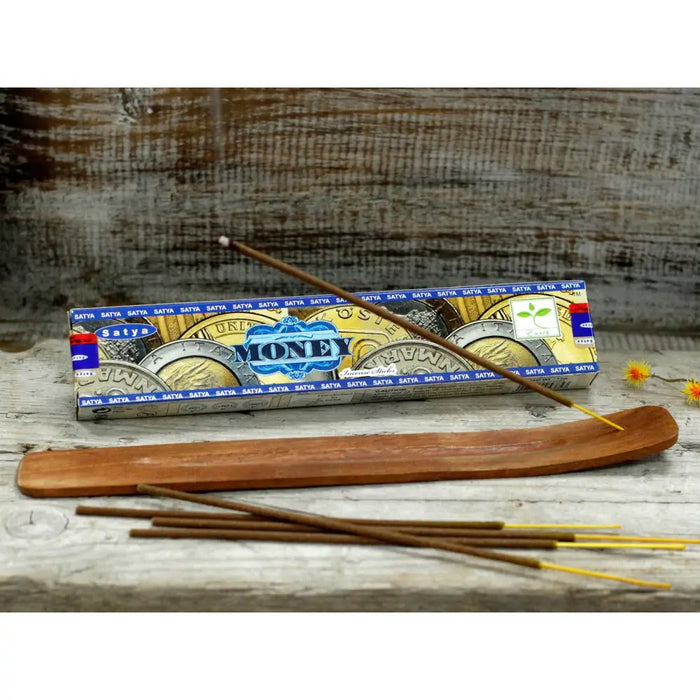 A wooden satya incense sticks holder with smooth polished surface and natural wood grain for money incense use