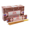 Brown cardboard box of satya incense sticks musk with white label red text next to loose golden brown incense sticks