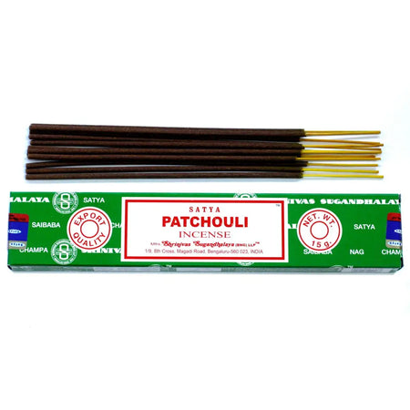A box of satya incense sticks patchouli with dark brown wooden sticks and golden tips in green packaging