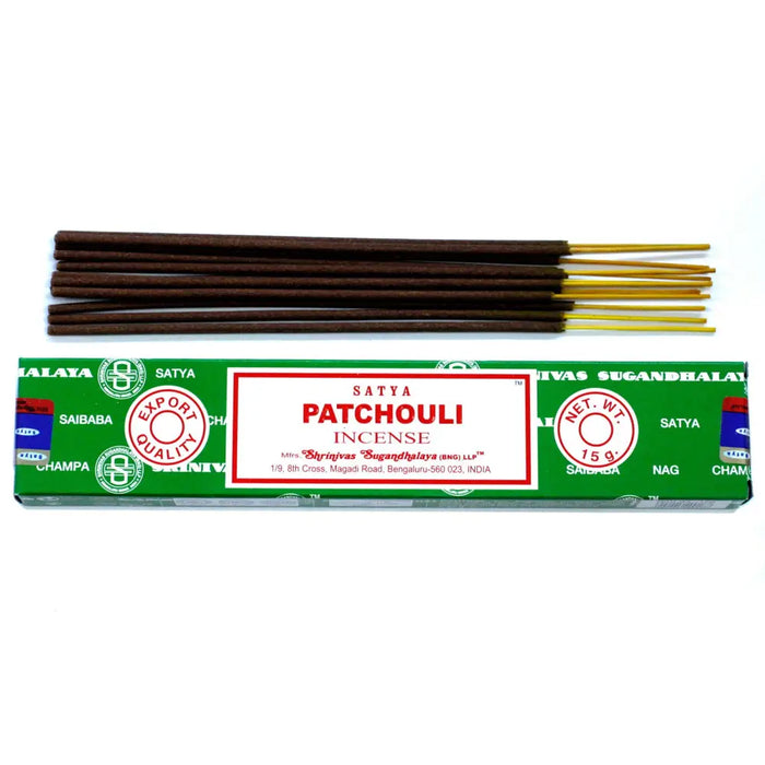 A box of satya incense sticks patchouli with dark brown wooden sticks and golden tips in green packaging
