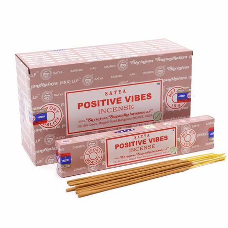 A box of satya incense sticks positive vibes with pink and white packaging and red lettering