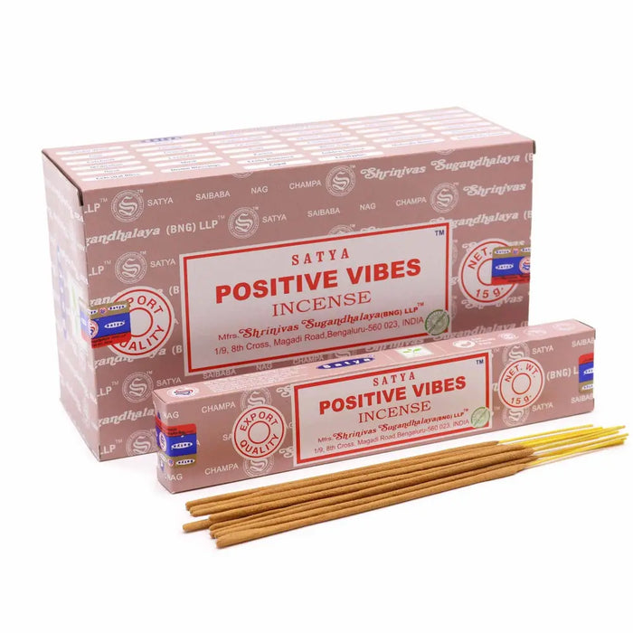 A box of satya incense sticks positive vibes with pink and white packaging and red lettering