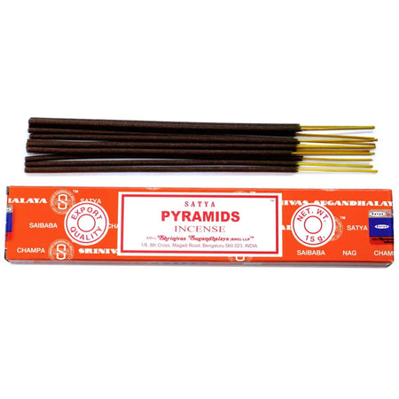 Orange-packaged satya incense sticks with dark brown wooden bodies and golden tips shown in pyramid shape packaging