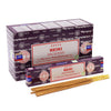 A box of satya incense sticks reiki with dark purple and white design and gold-colored sticks arranged beside it