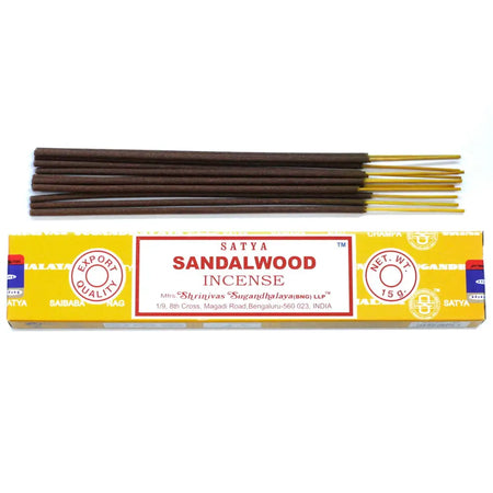 Yellow-packaged satya incense sticks with sandalwood scent dark brown sticks and golden tips