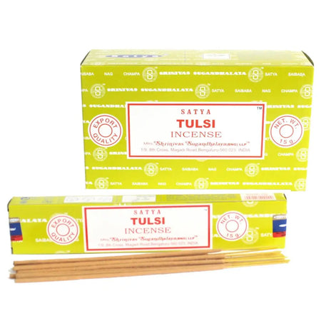 Bright yellow rectangular boxes of satya incense sticks labeled tulsi with red and black text on white labels