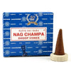 A brown satya nag champa incense cone in a white ceramic holder next to its blue nag champa branded box