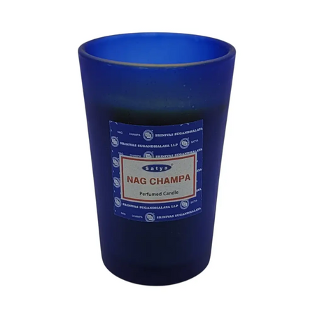 Deep blue glass jar holding a satya nag champa scented candle with frosted blue glass container