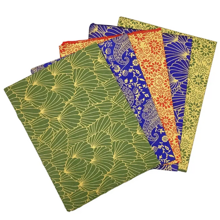 A set of five colorful lokta paper gift wraps with floral and paisley patterns in green blue orange and yellow covers