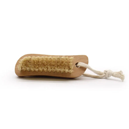 Natural wood-handled scrape brush with dense light brown bristles and white cotton loop for foot care use