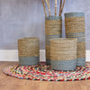 Tall cylindrical woven vases with beige and muted blue stripes made from textured seagrass and raffia rope material