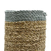 A cylindrical woven vase with a gray rope rim and natural beige raffia body from the seagrass abu-abu set