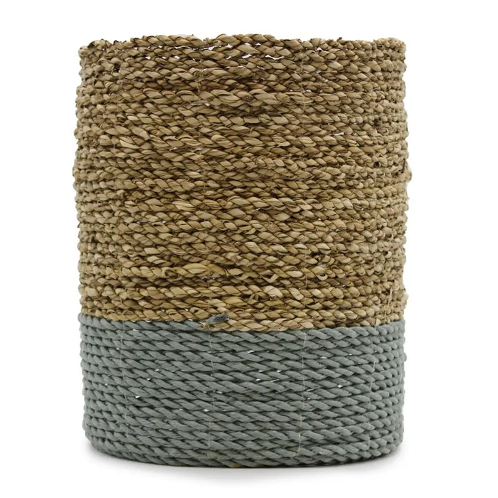 A cylindrical woven vase with beige and gray braided seagrass and raffia fibers in a set with bins