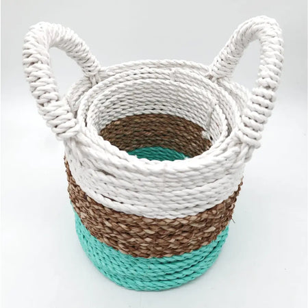 A woven seagrass basket set with white brown and teal stripes and thick braided handles for storage use