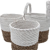 A set of 3 natural and white woven seagrass baskets with braided handles for storage and organization
