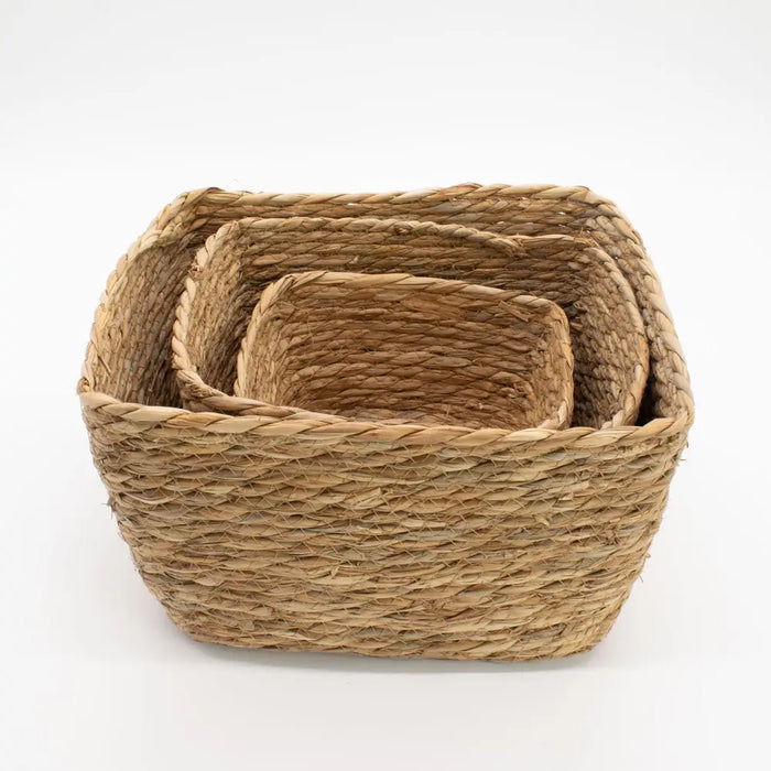 Set of three natural seagrass square baskets woven from seagrass nested to fit together for storage and organization