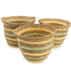 Three woven seagrass and straw baskets with yellow and green stripes stacked as a set of 3 storage baskets