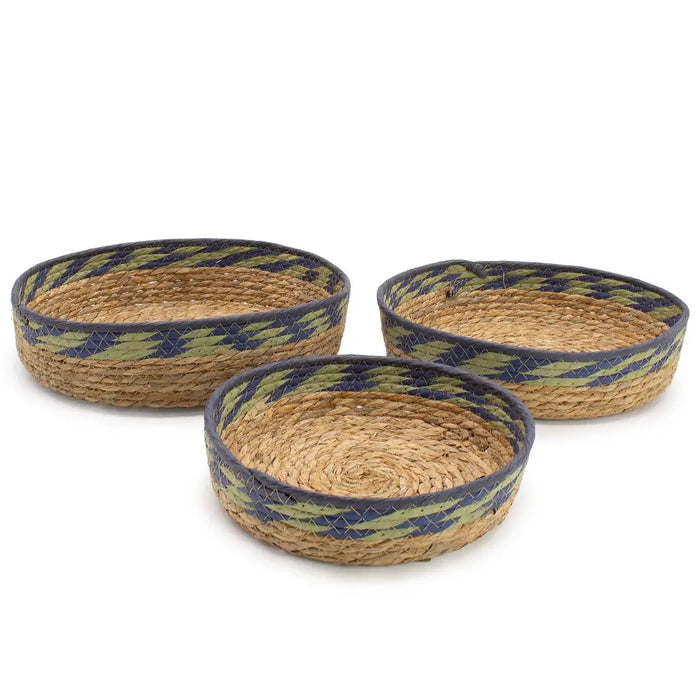 Set of three woven seagrass tray baskets with navy and olive green geometric trim in natural straw material
