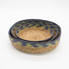Set of three nested tray baskets with natural seagrass bodies and navy blue and olive green patterned rims