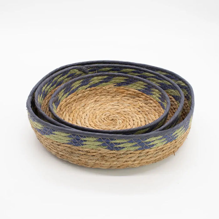 Set of three nested tray baskets with natural seagrass bodies and navy blue and olive green patterned rims