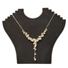 A gold-toned seed pearl and gemstone chip necklace with freshwater pearls and crystals on a black velvet bust