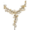 Seed pearl and gemstone chip necklace with v-shaped design featuring cream pearls and gold crystals on silver chain