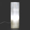 A translucent white selenite block lamp with etched chakra symbols glowing softly from within