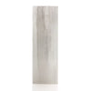 A tall slender selenite block lamp with a light gray wood grain texture in a rectangular shape called tree of life