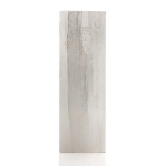 A tall slender selenite block lamp with a light gray wood grain texture in a rectangular shape called tree of life