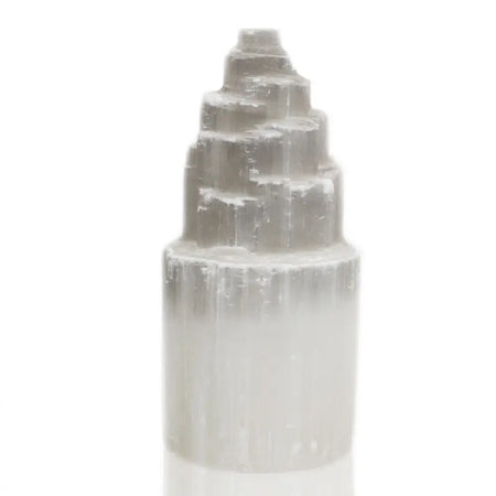 A translucent pale gray selenite tower lamp with a stepped pyramid top and smooth cylindrical base in 20 cm size